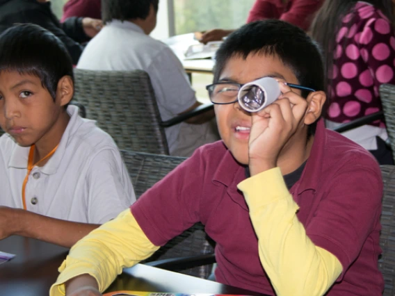 Visiting student looking through lens