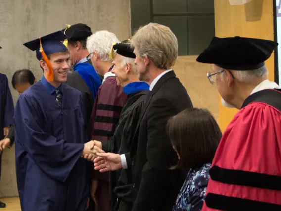 2015 Winter Commencement Student Shaking Hands with Board