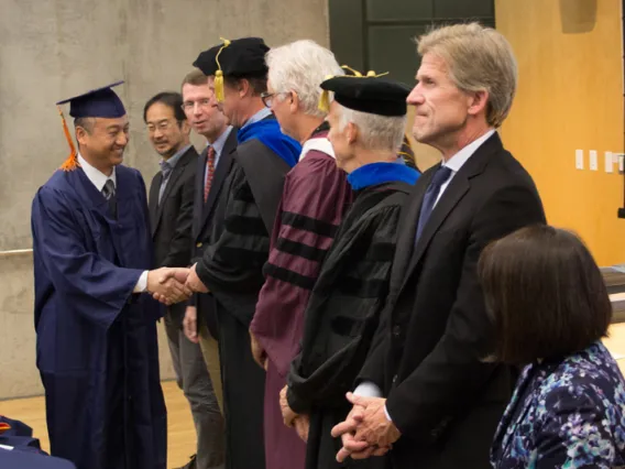 2015 Winter Commencement Student Shaking Hands with Board