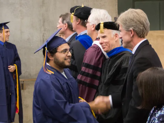 2015 Winter Commencement Students Shaking Hands with Board