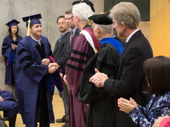 2015 Winter Commencement Student Shaking Hands with Board