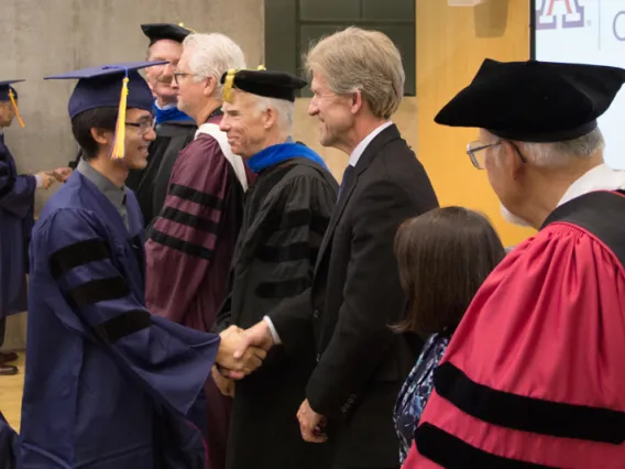 2015 Winter Commencement Student Shaking Hands with Board