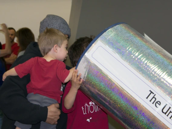 Laser Fun Day participants looking at telescope