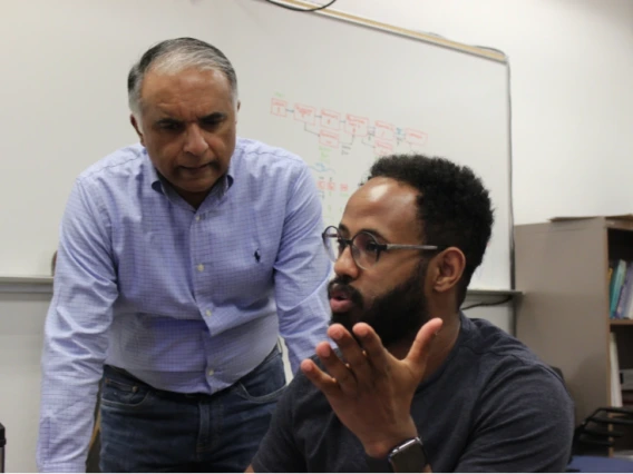 Left to right: Abhijit Mahalanobis with doctoral student Natnael Daba.