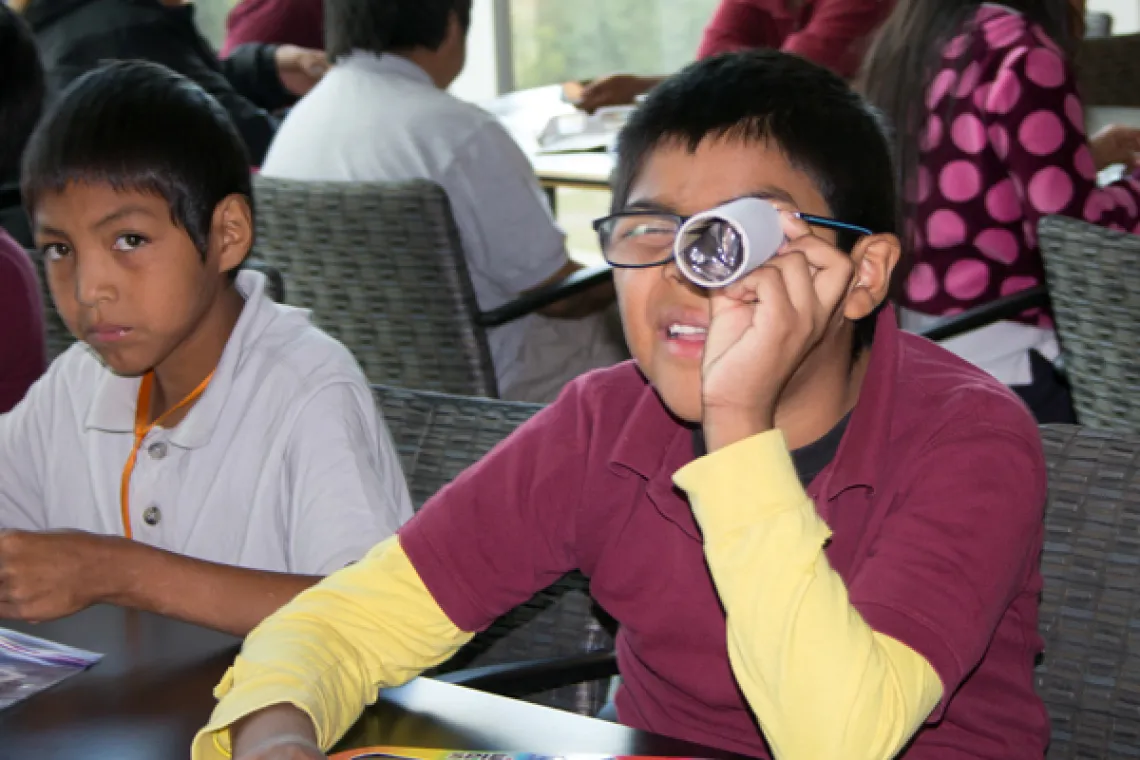 Visiting student looking through lens