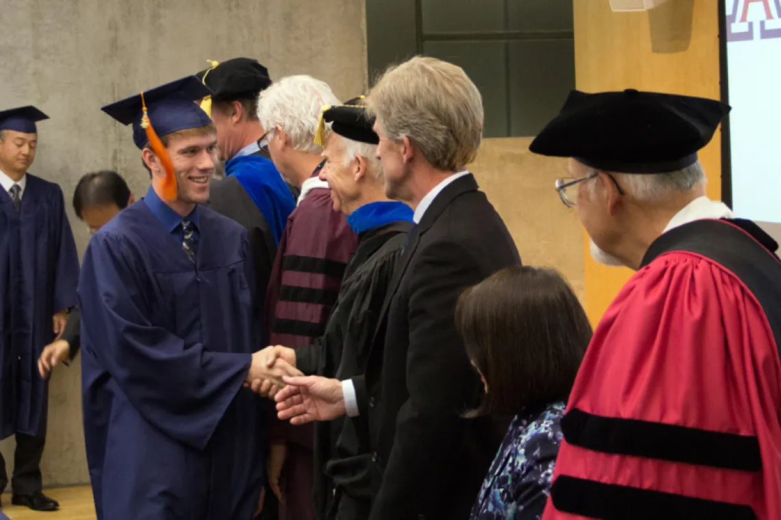 2015 Winter Commencement Student Shaking Hands with Board