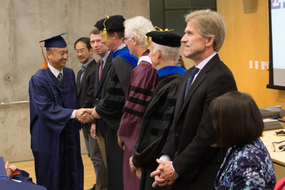 2015 Winter Commencement Student Shaking Hands with Board