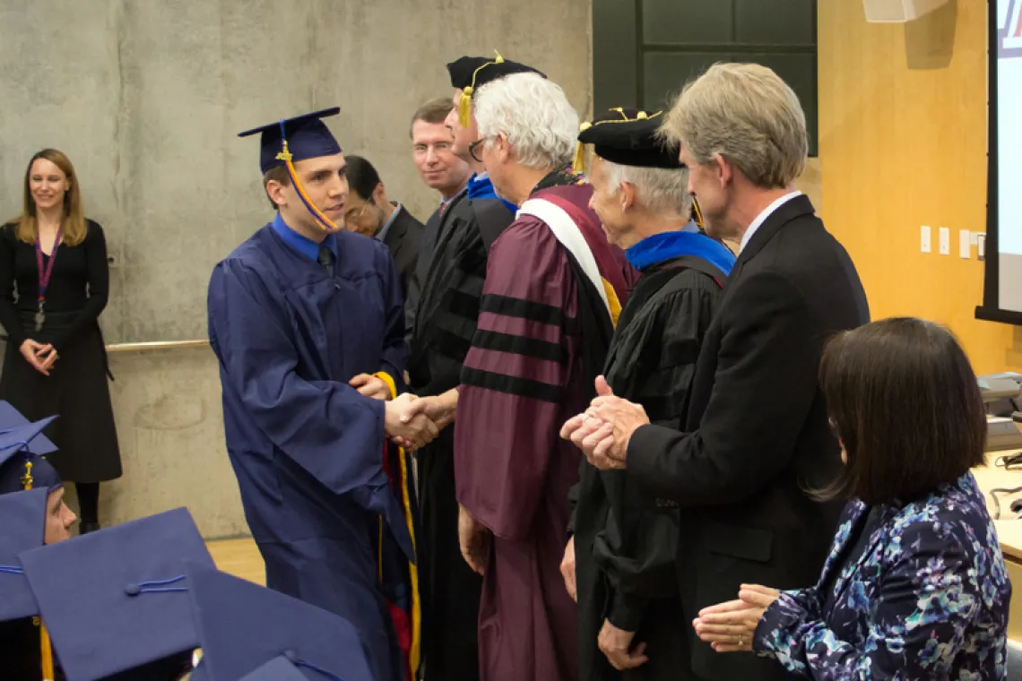 2015 Winter Commencement Students Shaking Hands with Board