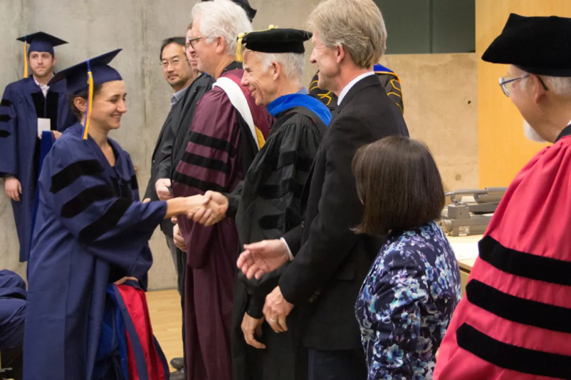 2015 Winter Commencement Student Shaking Hands with Board