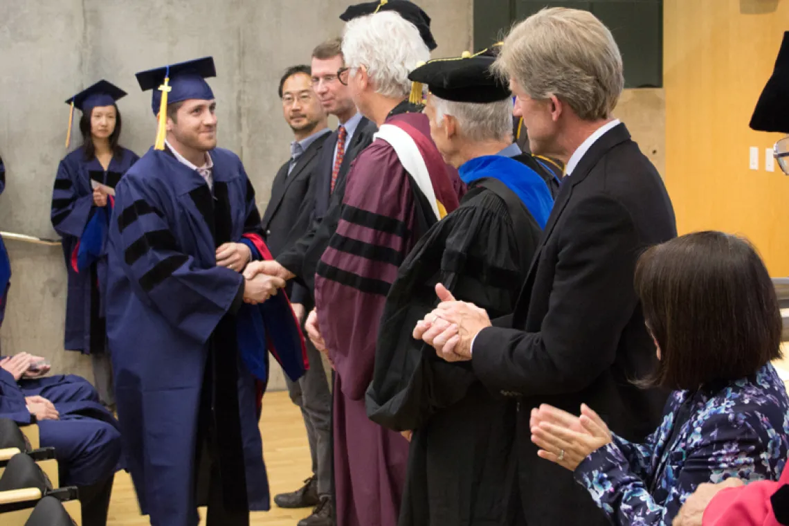 2015 Winter Commencement Student Shaking Hands with Board