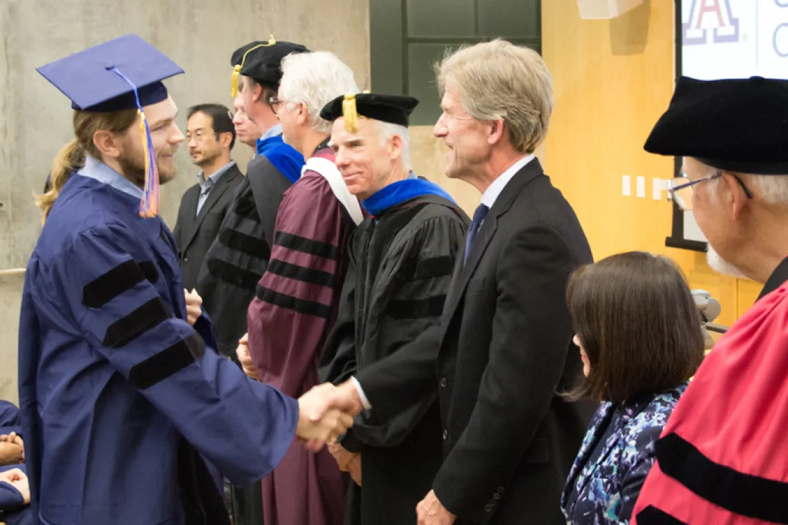 2015 Winter Commencement Student Shaking Hands with Board