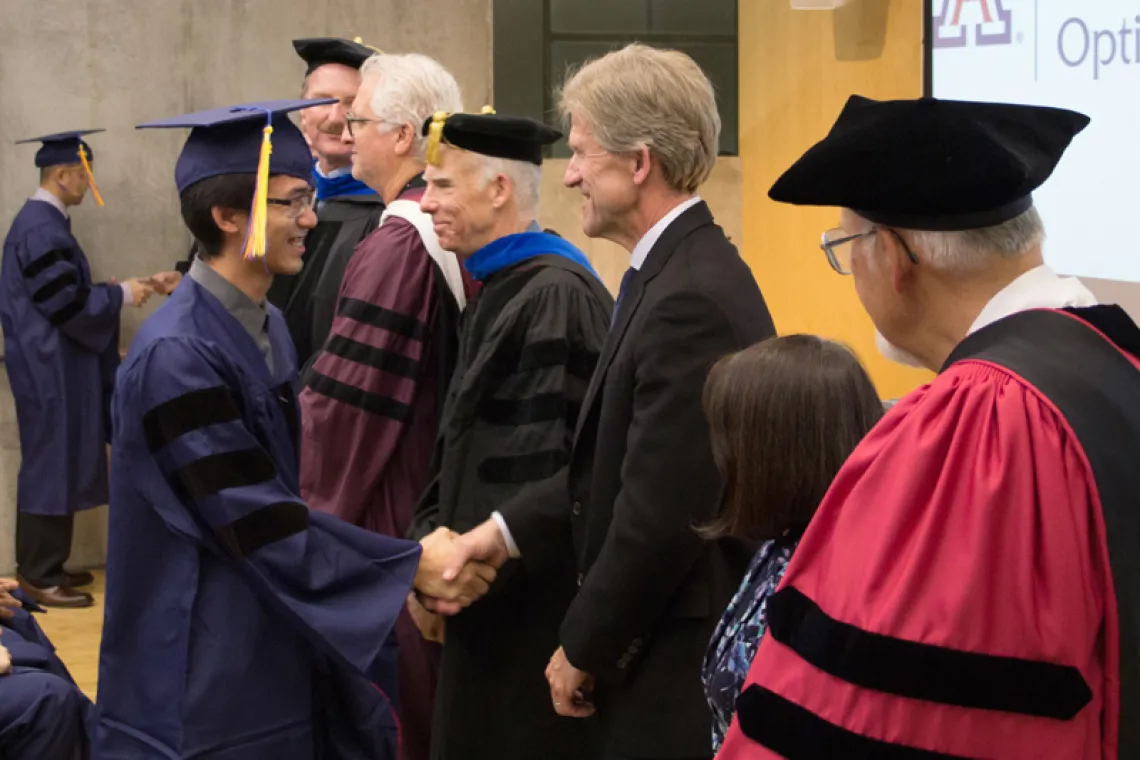 2015 Winter Commencement Student Shaking Hands with Board