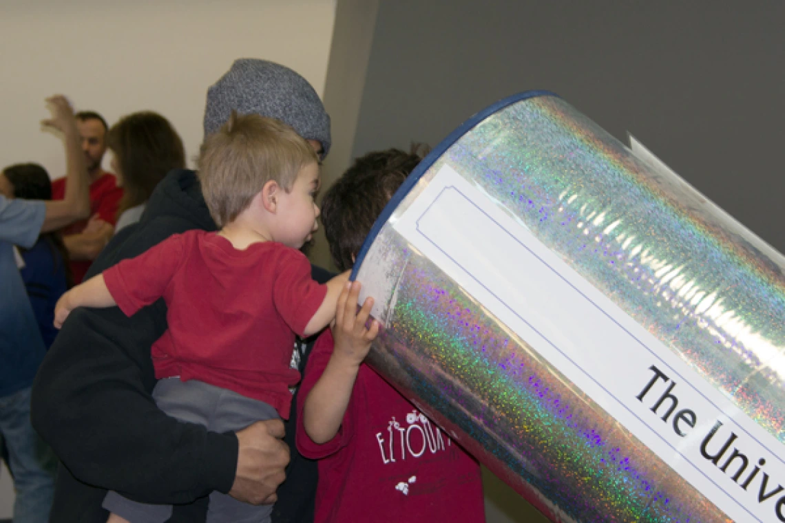 Laser Fun Day participants looking at telescope